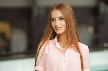 Redhead escort in pink dress